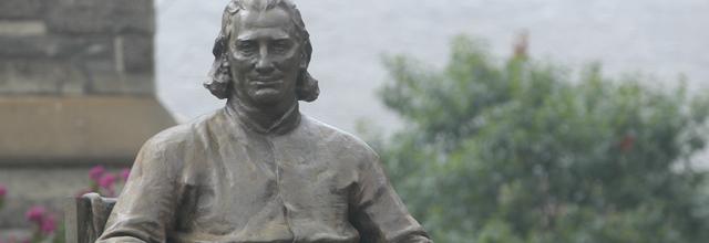 Close-up of John Carroll statue in front of Healy Hall